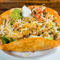 Taco Salad · Our House Salad with Chicken, Carne Asada, Carnitas, or Ground Beef, Refried Beans, Com Chee...