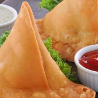 Vegetable Samosa · Crispy turnover stuffed with spiced potatoes and peas served with mint green sauce.