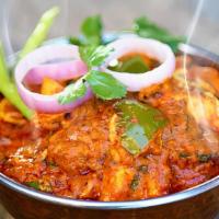 Paneer Tikka Masala · Clay oven grilled cottage cheese cubes simmered in a creamy tomato-onion based gravy.