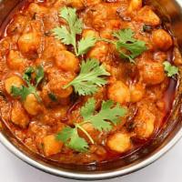 Chana Masala · Tender chickpea cooked with tomato-onion based gravy and house spices.