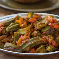 Okra Masala · Crispy okra cooked with ginger, onions, tomatoes, herbs and spices.