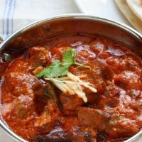 Lamb Curry · Marinated meat cooked in tomato-onion based gravy with Indian spices, herbs aromatic flavor.