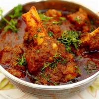 Goat Curry · Marinated meat cooked in tomato-onion based gravy with Indian spices, herbs aromatic flavor.