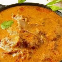 Goat Korma · Traditional Mughlai meat curry cooked in rich creamy tomato-onion gravy with cashew herbs an...