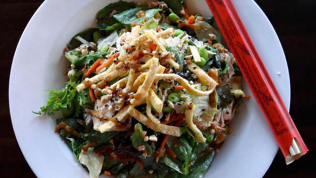 Lunch Asian Chicken Salad · Spring mix, sriracha noodles, edamame, green onions, crispy wontons, carrots, sesame vinaigrette, peanut sauce, and peanuts.