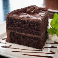 Lunch Double Layer Chocolate Cake · Buttercream chocolate frosting and homemade whipped cream and chocolate sauce.