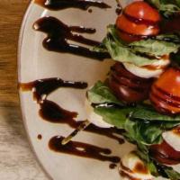 Caprese Skewers · Fresh Mozzarella, Garden-Fresh Cherry Tomatoes Topped with Fresh Basil and Balsamic Drizzle.