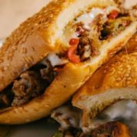 Philly Cheesesteak · Thin Sliced Tri-Tip, Sautéed Peppers, Onion, Mushrooms, Mozzarella, on a Seeded Hoagie Roll.