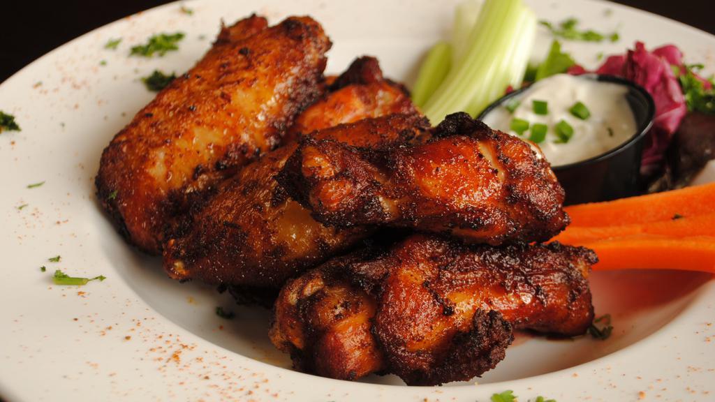 Award Winning Wings · Dry-rubbed with our own special seasonings, smoked over pecan wood for three hours and flash fried. Made with love!.