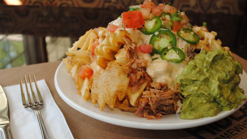 Hideaway Nachos · Gluten free. Pulled pork and creamy queso on a bed of crispy waffle fries, with refried beans, jalapeños, pico de gallo and house-made guacamole.