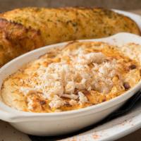 Chesapeake Crab Dip · Three creamy cheeses, backfin blue crab meat and a hint of old bay. Served with fresh baguet...