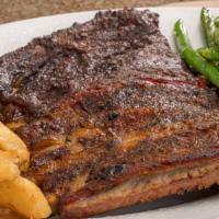 St Louis Ribs (1/2 Rack) · Dry-rubbed and bathed in pecan smoke for six hours. Fall off the bone tender!.
