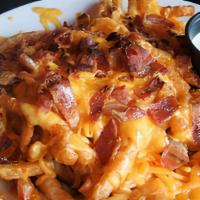 Bacon Cheese Fries · A large order of fries topped with cheddar jack cheese and bacon bits. Served with ranch dre...