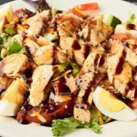 Cobb Chicken Salad · Sliced chicken breast grilled with bacon over a bed of mixed lettuce, tomatoes, cucumbers, c...