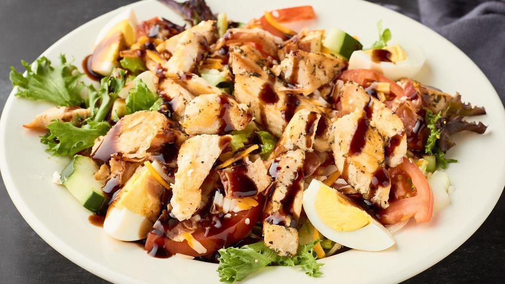Cobb Chicken Salad · Sliced chicken breast grilled with bacon over a bed of mixed lettuce, tomatoes, cucumbers, cheddar jack cheese and boiled eggs.  Drizzled with our balsamic glaze reduction.