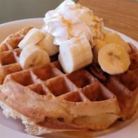 Banana Pecan Waffle · Served with bananas and pecans and topped whipped cream and caramel drizzle.