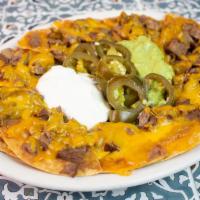 Fajita Nachos · Beef or chicken, served with guacamole, sour cream, and jalapenos.