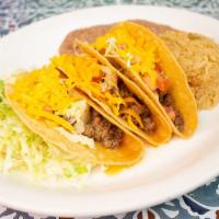 Crispy Taco Plate · Three ground beef or shredded chicken tacos with lettuce tomato and cheese. Includes rice, b...