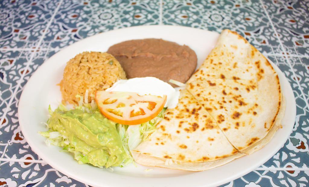 Quesadilla Plate · Large flour tortilla filled with cheese and either beef or chicken fajitas, with a side of guacamole salad and sour cream. Includes rice, beans and two tortillas.