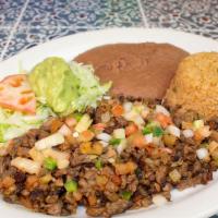 Carne A La Mexicana · Asada grilled with pico de gallo, served with guacamole salad. Includes rice, beans and two ...