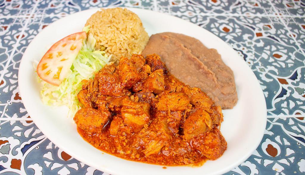 Carne De Puerco En Chile Colorado · Topped with lettuce and tomato. Includes rice, beans and two tortillas.