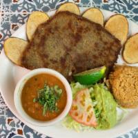 Milanesa Plate · Breaded beef steak, served with potatoes, borracho beans, and guacamole salad. Includes rice...