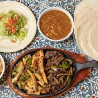 Fajita Family Order · One pound of chicken or beef fajitas, served with your choice of refried or charro beans, ri...