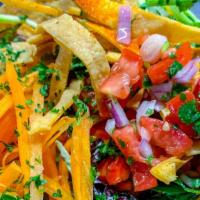 Taco Salad · Wheat tortilla bowl,  black beans, carrots, greens, pico de gallo, roasted salsa, tortilla s...