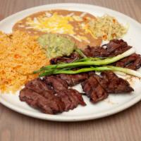 Carne Asada · Fresh skirt steak butterflied and charbroiled to your liking. Served with rice, beans, guaca...