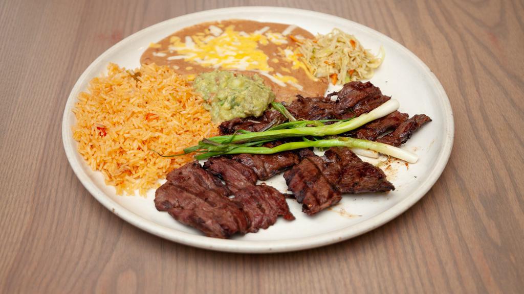 Carne Asada · Fresh skirt steak butterflied and charbroiled to your liking. Served with rice, beans, guacamole, and warm tortillas. Garnished with grilled scallions and our special Mexican coleslaw.