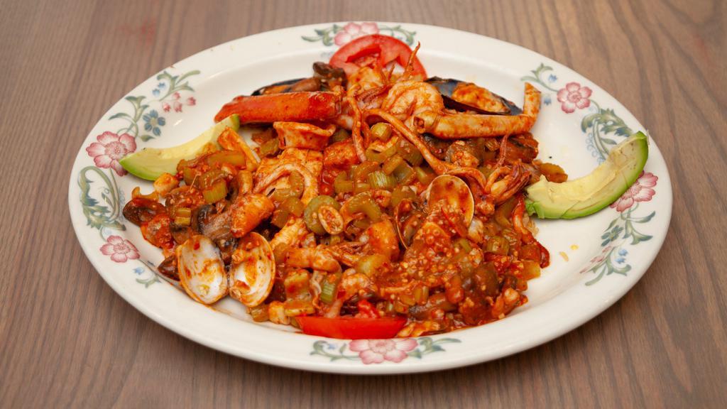Mariscos Jarrochos · Fresh scallops, shrimp, crab legs, octopus, and fish sautéed with garlic and served with a special sauce on a bed of rice. A seafood lover's choice.