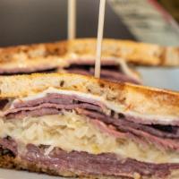 Ruben · Corned beef, Swiss cheese, sauerkraut, and sweet Russian dressing on grilled marbled rye.