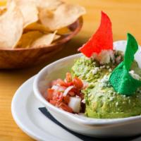Guacamole Dip · Chunky avocado blended with tomatoes, onions, and spices. Served with corn tortilla chips.