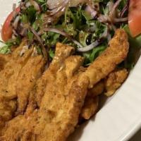 Chicken Milanese · breaded breast of chicken pan fried topped with baby greens, red onions tomato salad and sha...