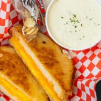 Grilled Cheese & Chowder · Crispy grilled sourdough bread with melted Cheddar and American cheeses, with a bowl of our ...