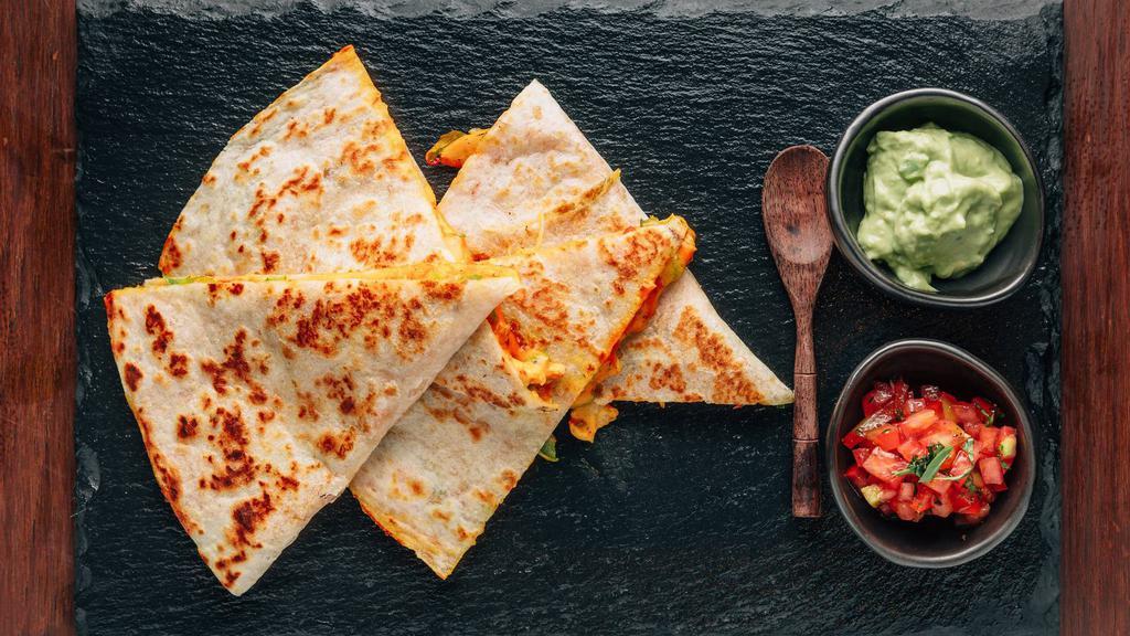 Chicharron Prensado Quesadilla · A must try! Soft, foot long flour tortilla filled with fatty, porky carnitas and crunchy pork skin with guajillo chiles and tons of stretchy, white Mexican cheese. Griddled until brown and toasty.