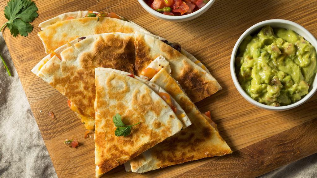 Squash Blossom Quesadilla · Soft, foot long flour tortilla filled with delicate, sautéed squash blossoms and tons of stretchy, white Mexican cheese. Griddled until brown and toasty.