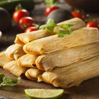 Oaxaqueño Tamale · Tender shredded chicken with our special blend of spicy Mexican chiles steamed in a banana l...