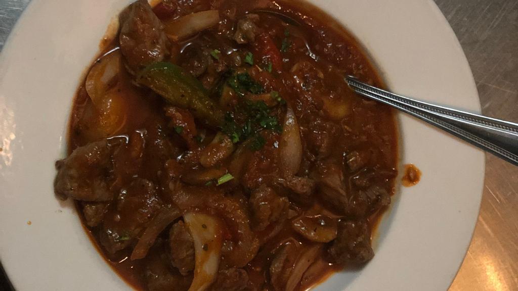 Filetillo De Lomo · Tender strips of beef sautéed with garlic, onions, mushrooms and peppers in a rioja wine sauce.