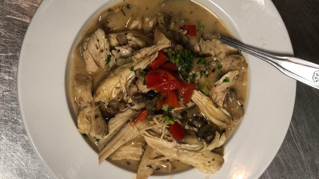 Pollo Al Ajillo · Seasoned chicken and mushrooms sautéed in extra virgin olive oil, minced garlic, diced peppers, and fresh parsley with a touch of white wine.
