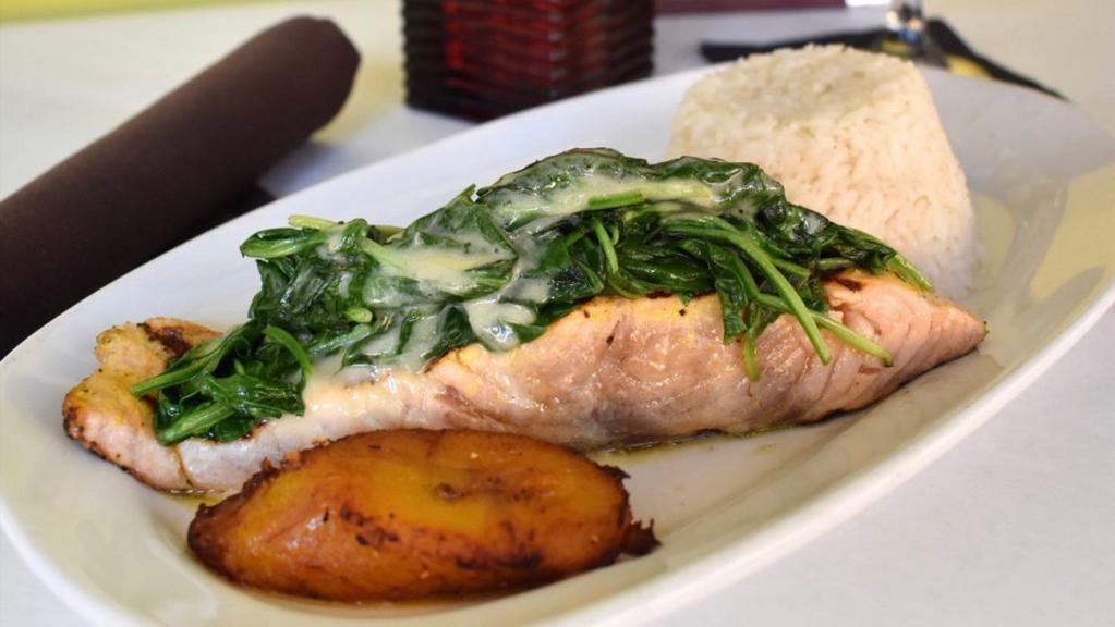 Salmon Ala Parrilla · Gluten free. Fresh north Atlantic salmon seasoned and grilled, topped with sautéed baby spinach and laced with wine lemon sauce. Served with white rice and sweet plantains.