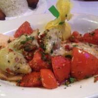 Trucha Al Modo Mio · Pan-seared rainbow trout, sautéed artichoke hearts, tomatoes, red peppers and capers laced w...