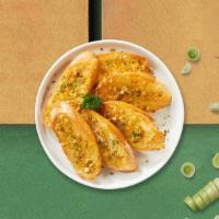 Garlic Bread · (2 pieces) Housemade bread toasted and garnished with butter, garlic, and parsley.