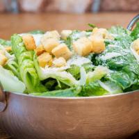 Caesar Salad · Caesar salad is served with parmigiana, romaine lettuce, romano cheese.