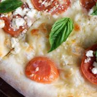 Margherita Pizza · Our margherita pizza is topped with basil, cheese, feta, garlic, garlic sauce, romano, tomato.