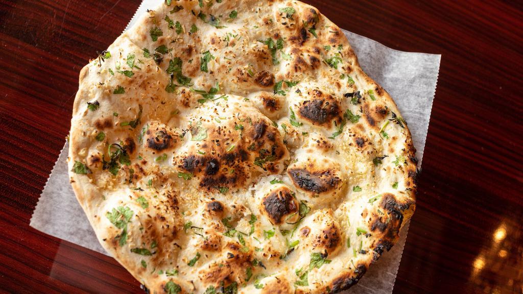 Garlic Naan · White flour bread topped with fresh garlic and cilantro.