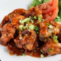 Gobi Manchurian · Vegan. Cauliflower fritters tossed in chili garlic sauce, soy sauce and topped with spring o...