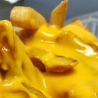 Nacho Cheese Fries · Topped with nacho cheese.