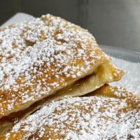 Apple Pie Calzone · Apple pie filling with caramel sauce topped with powdered sugar