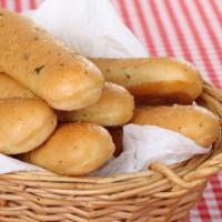 Breadsticks · Satisfying oven baked bread sticks glazed with garlic sauce and a special garlic Romano seas...